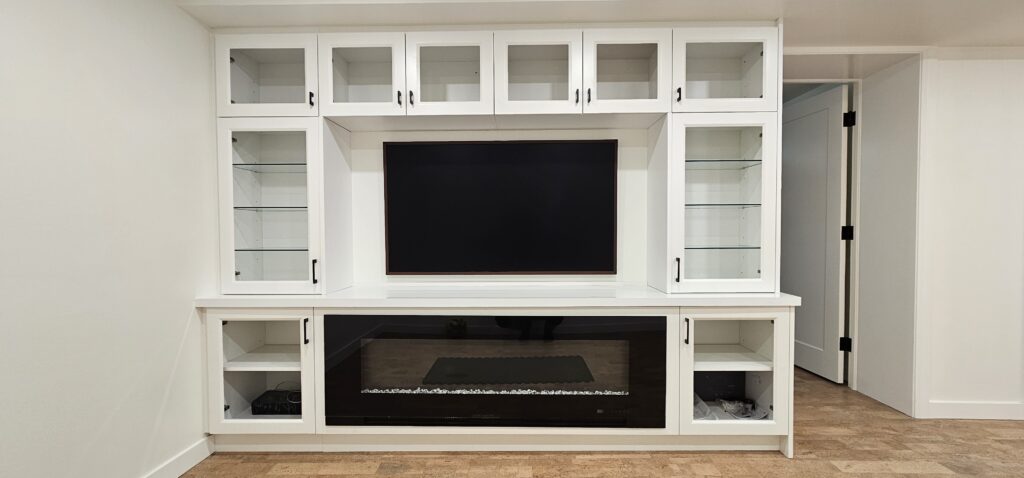 Custom basement entertainment unit and fireplace built by Elegant Design Inc. in Thunder Bay